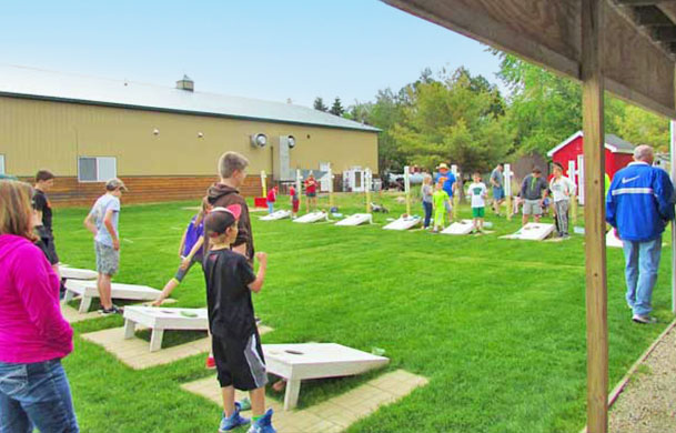 families playing cornhole at Adventure Bound Beaver Trails