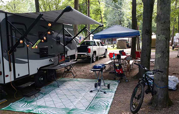 Water and electric campsite with fire ring and picnic table at Adventure Bound Eagle Valley